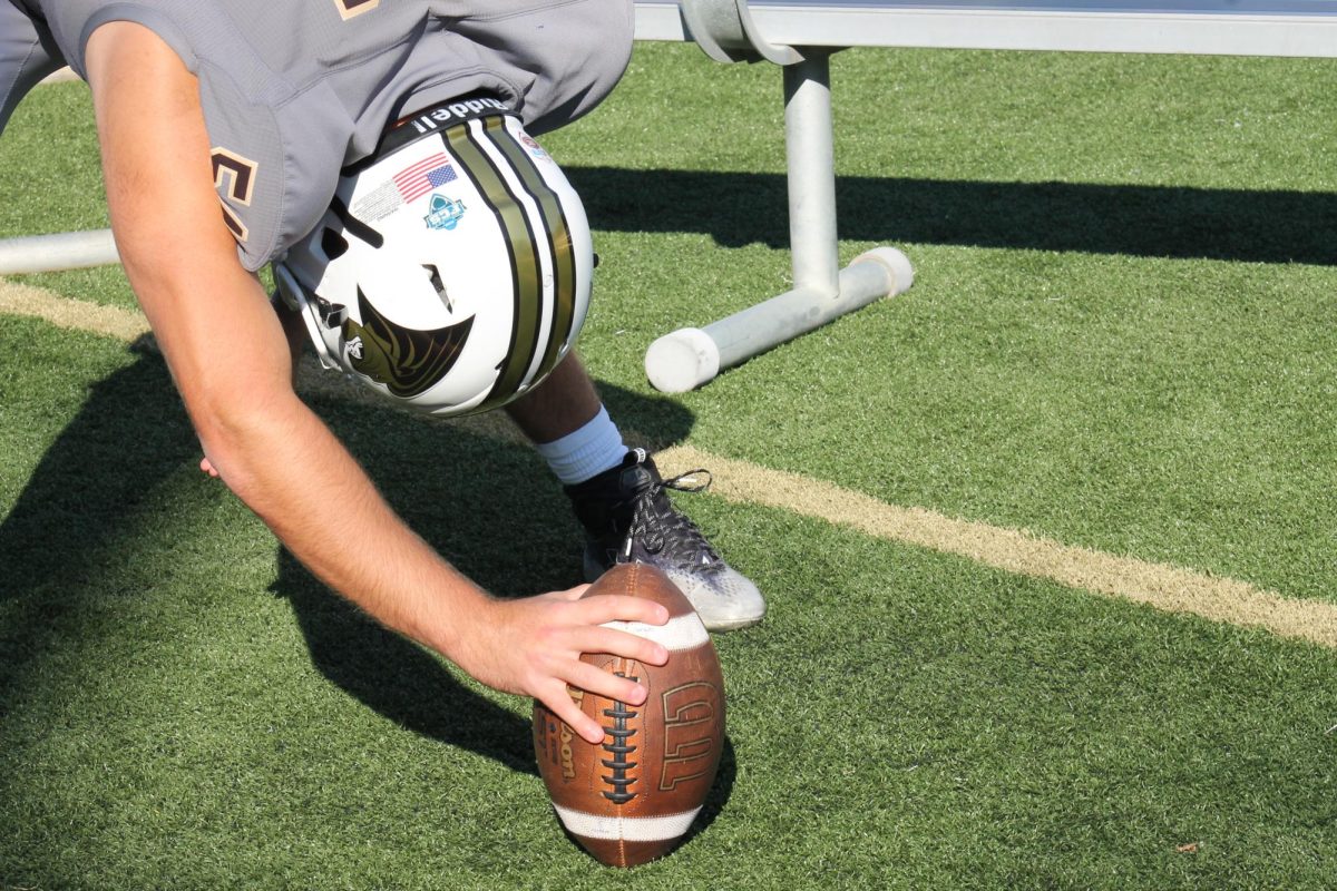 Long snapper Nelson Pipes practices snapping on the sidelines during a game against Bryant University. 