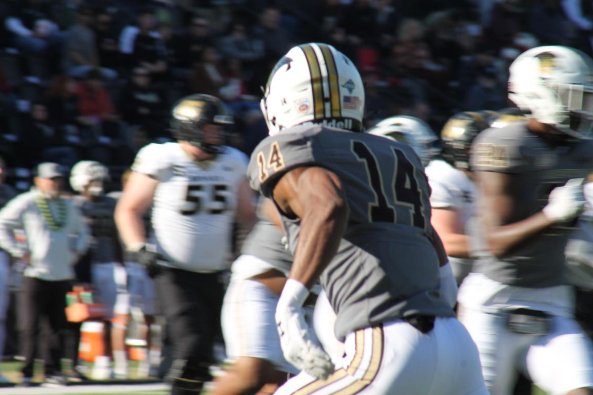 Defensive back Tre Bell runs to his left during a game against Bryant University. 