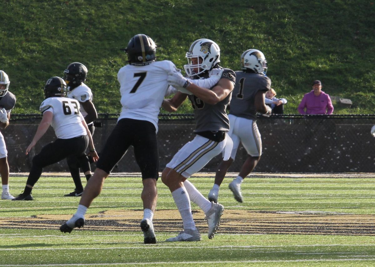 Running back Steve Hall and a Bryant University defender skirmish during a play. 