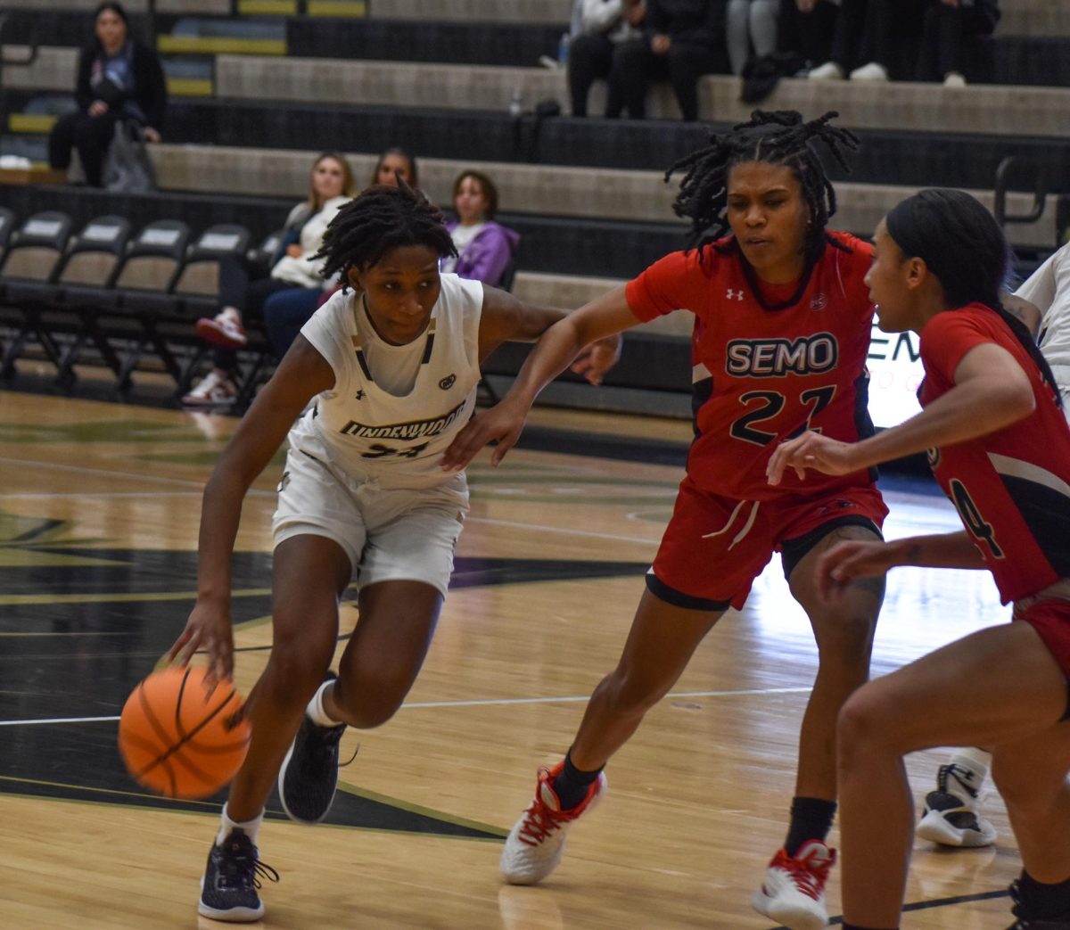 Guard Mykayla Cunningham dribbles past a SEMO defender with the ball. 