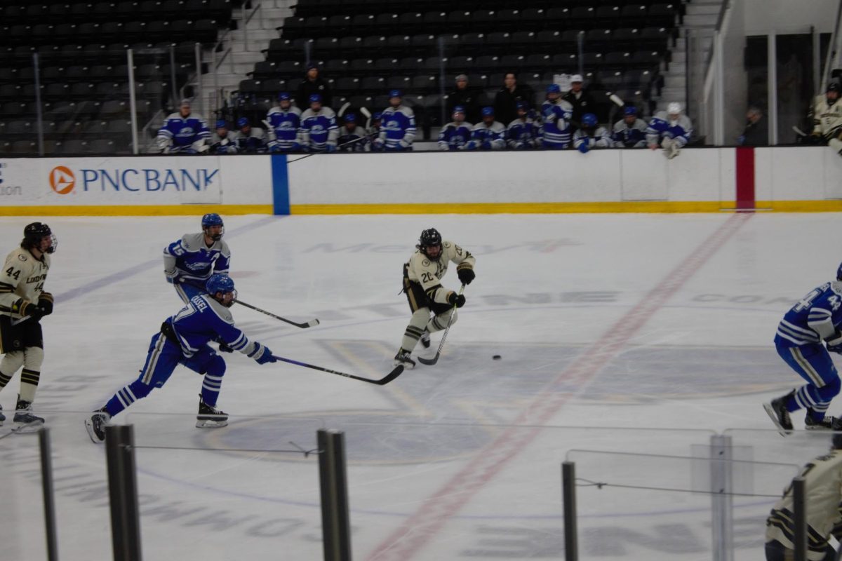 Forward Stanley Lucas drives the puck down ice against Concordia University. 