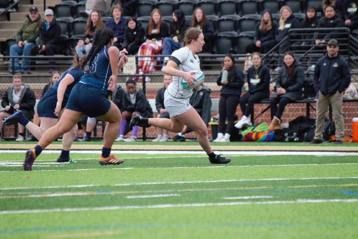 A Lindenwood Rugby player runs towards the try zone in a game against Brigham Young University. 