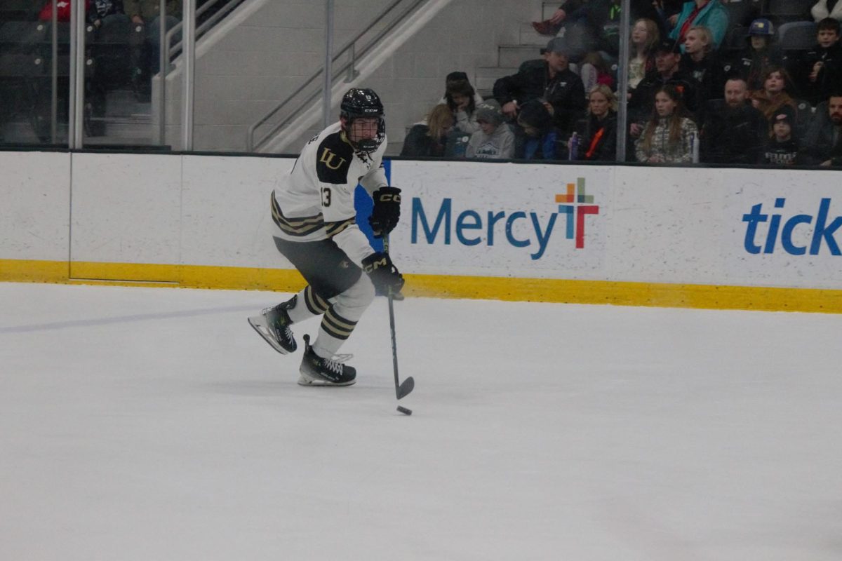 Zach Aughe moves the puck down the ice in a game against Alaska Anchorage.