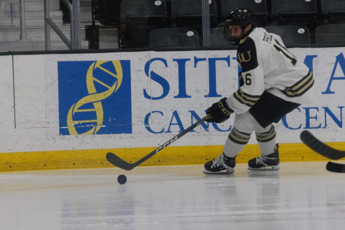 Caleb Price holds possession of the puck in a game against Alaska Anchorage. 