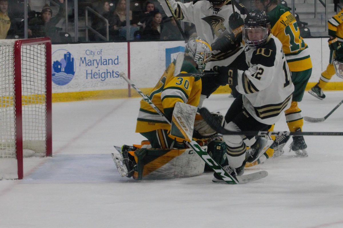 Ethan Zielke collides with the Alaska Anchorage Seawolves goalie. 