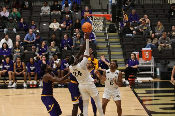Keenon Cole takes a shot at a contested basket against Western Illinois University.