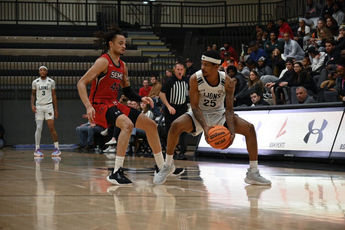 Guard Darius Beane looks onward with the ball, as a SEMO player arrives to defend him. 