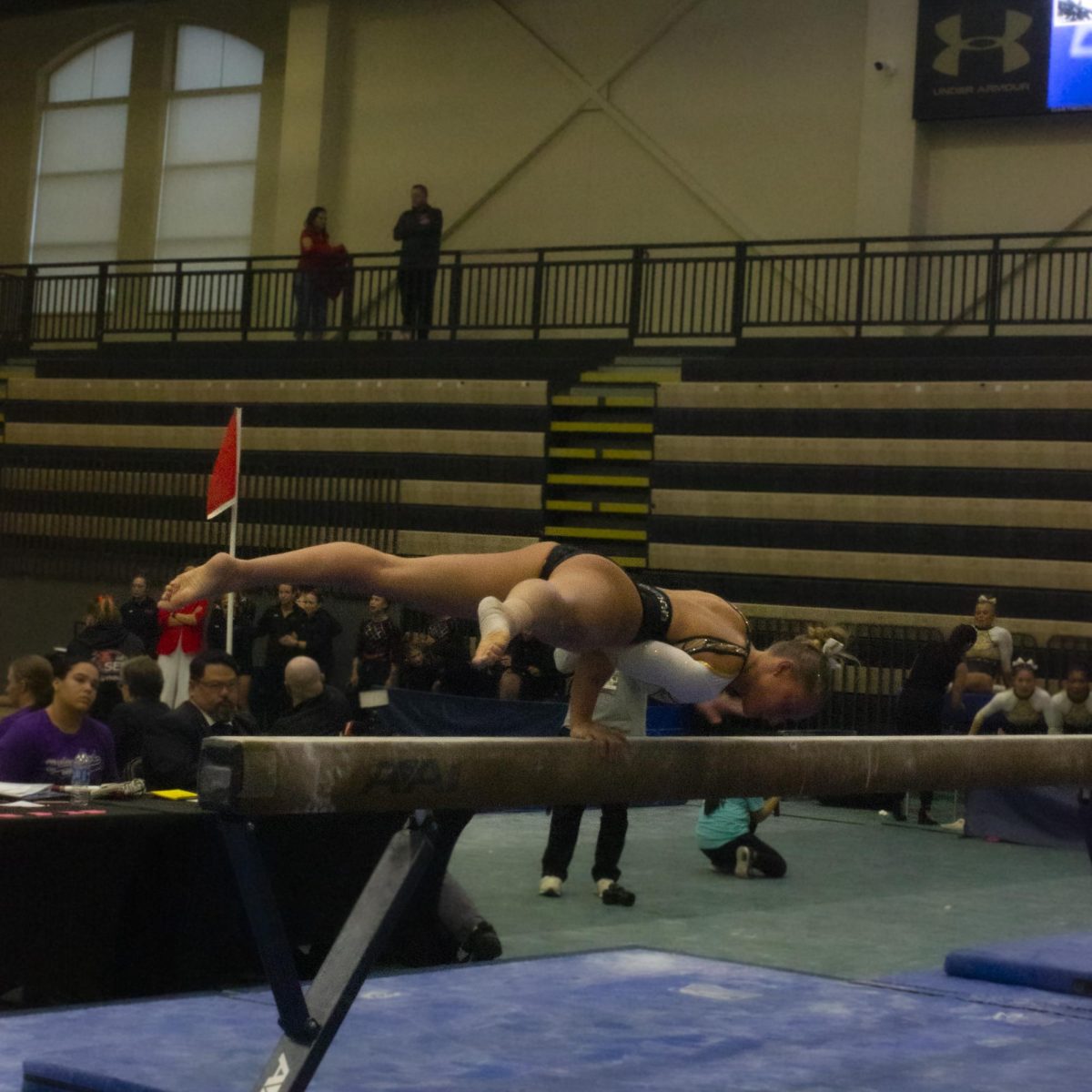Madison Rush competes on the beam competition during the Midwest Independent Conference championships. 