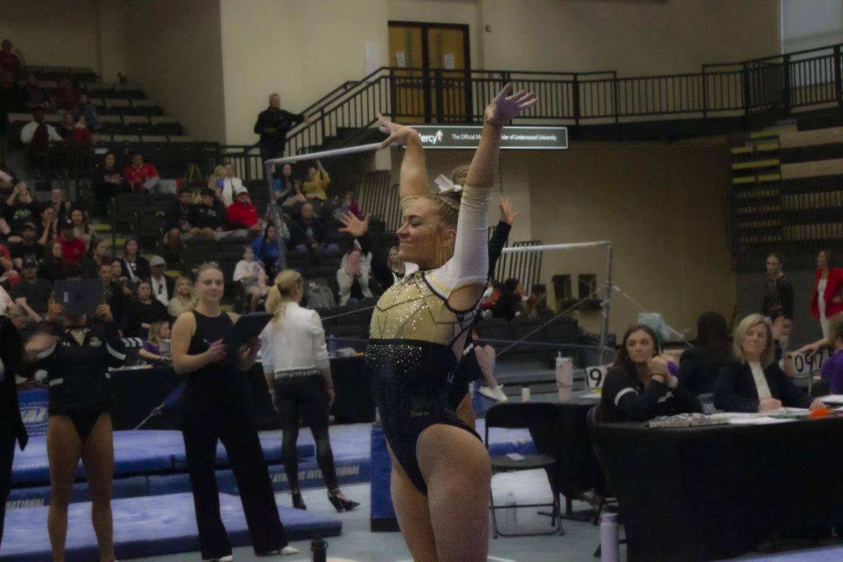 Madison Rush completes her routine while competing in the Midwest Independent Conference championship.