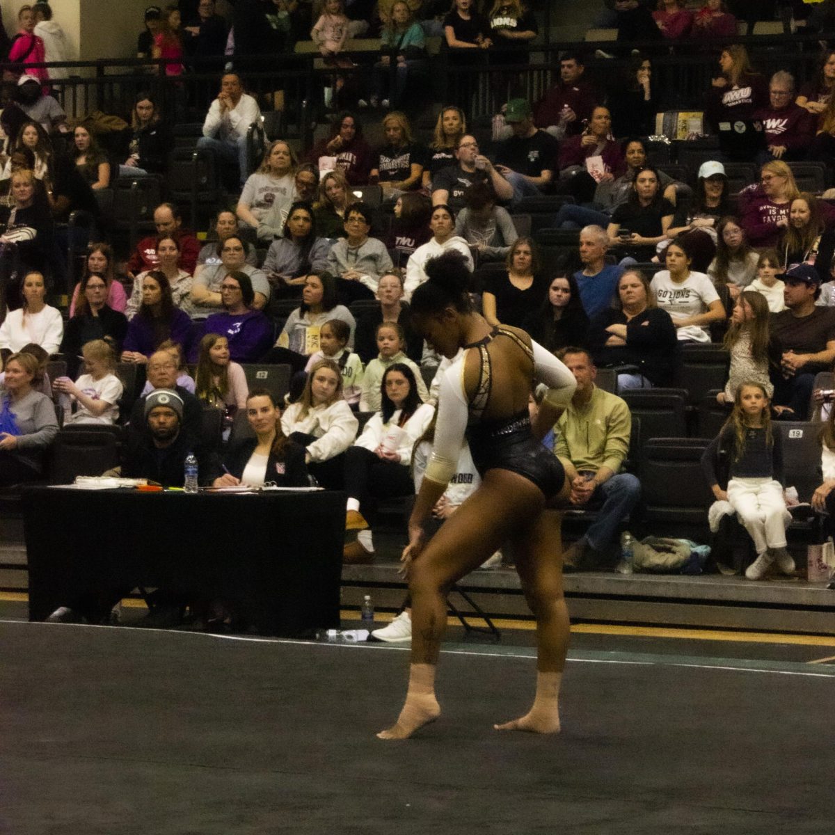 Trinity Caffey competes on the floor routine during the Midwest Independent Conference championships. 