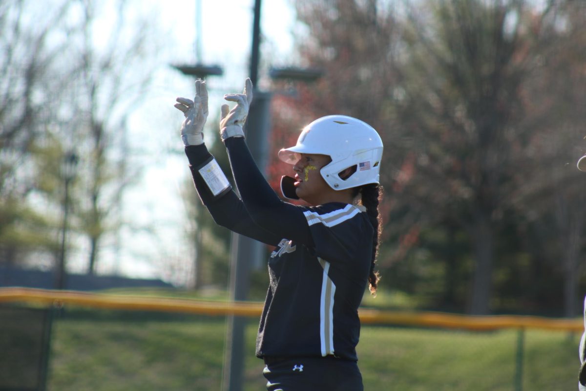 Mya Bethany celebrates towards the Lions dugout after recording a base hit against St. Louis University. 