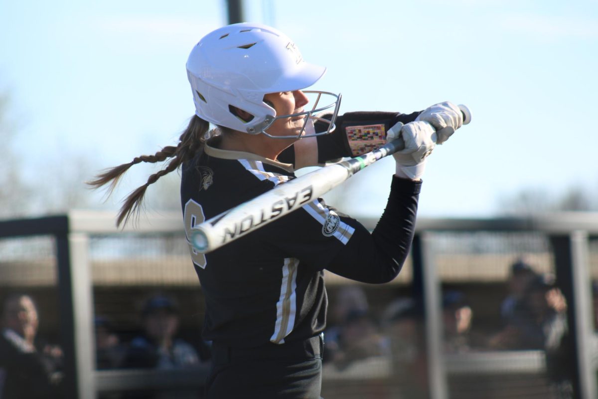 Ashley Gerber checks her swing in a game against St. Louis University. 
