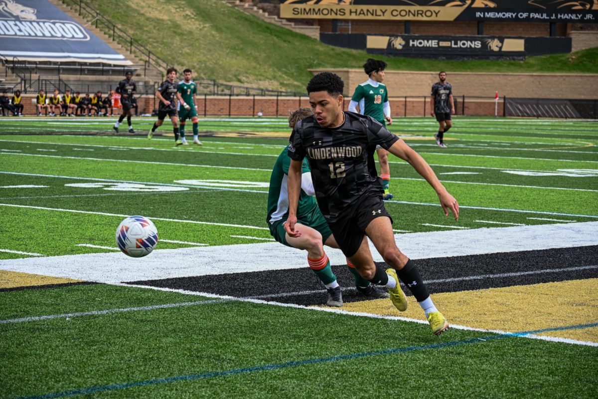 A Lindenwood Lion moves the ball past a Lincoln Trail College defender. 