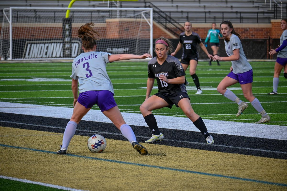 Reece Ward defends against an Evansville player with the ball.
