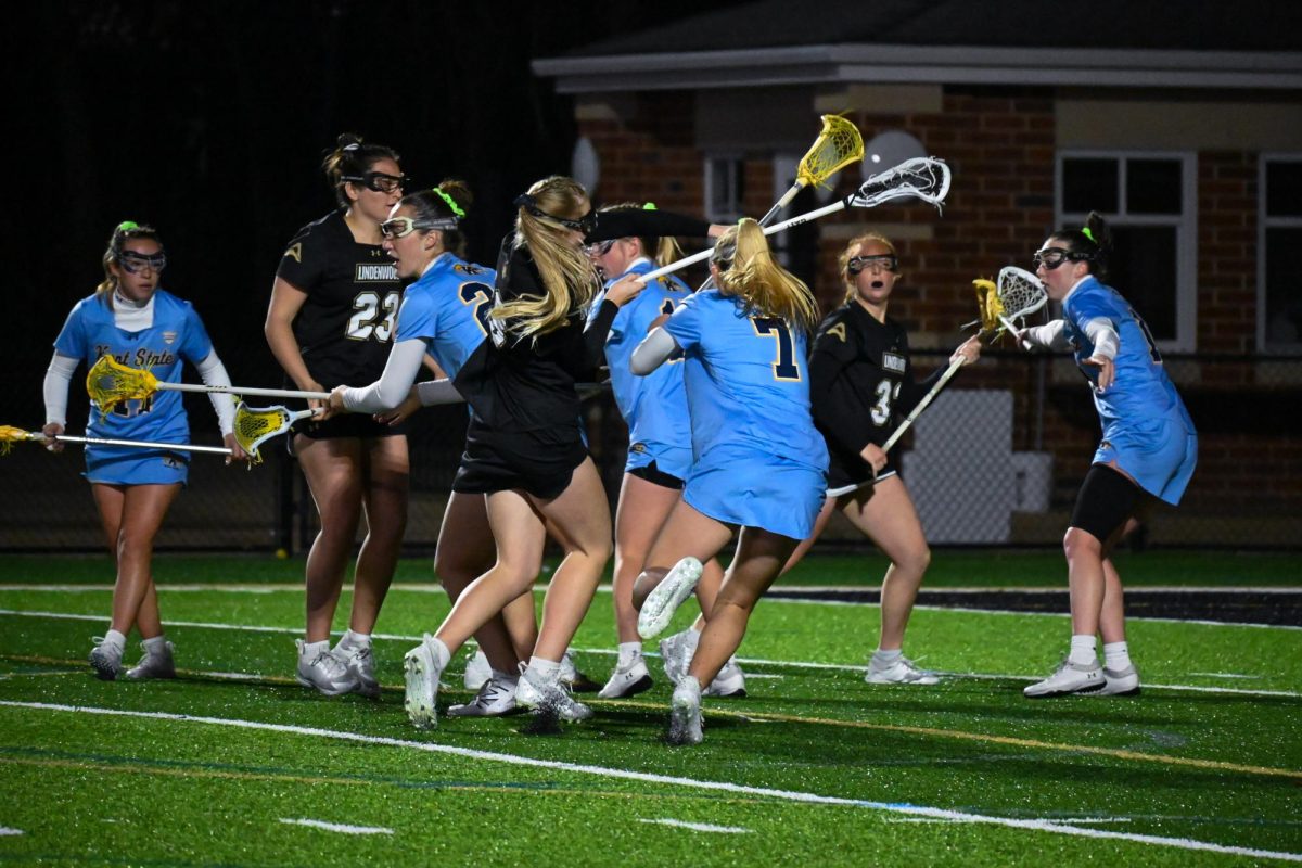 Members of Lindenwoods womens lacrosse team compete for the ball in a scrum of Kent State players.