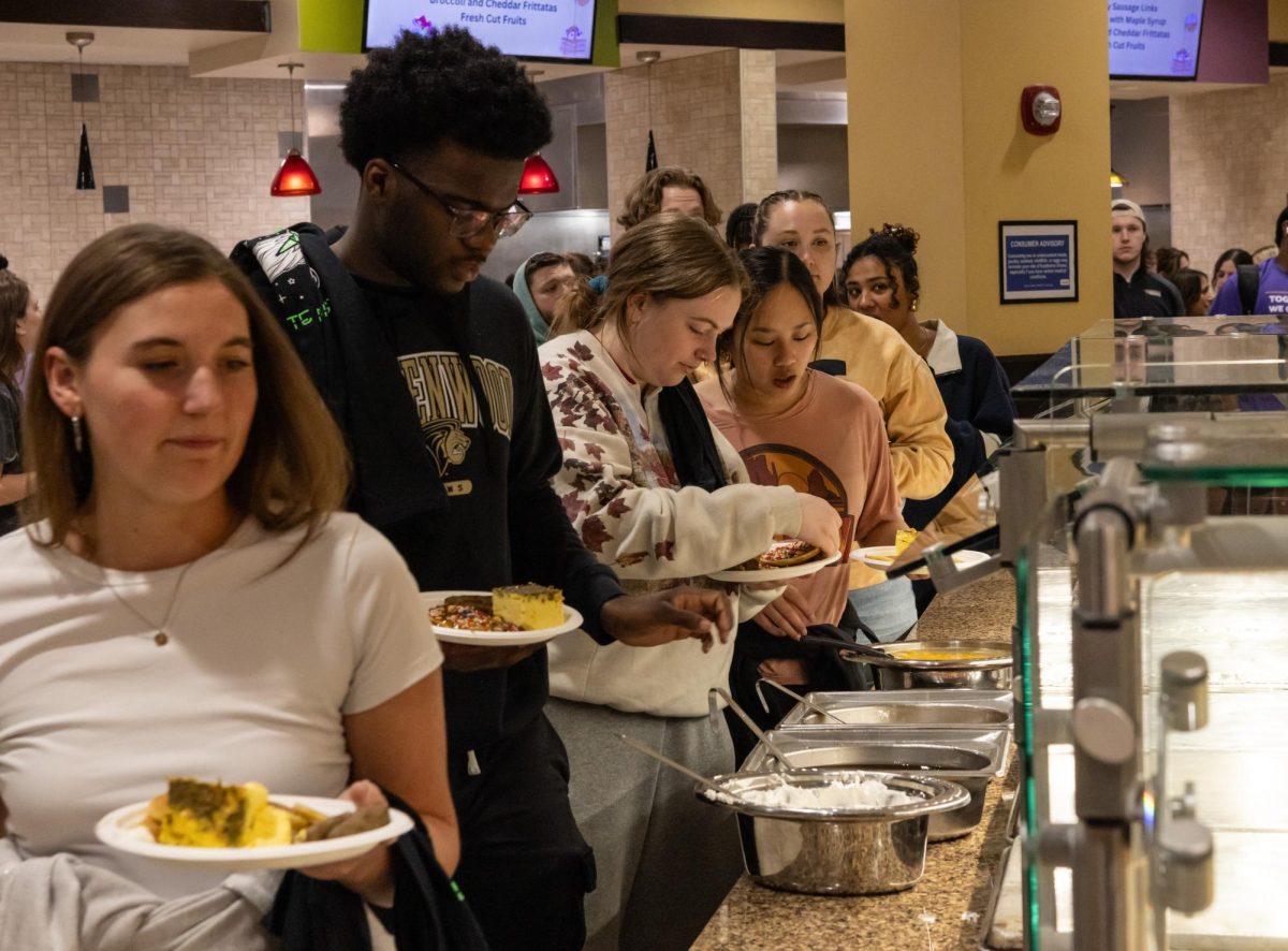 (Left to right) Olivia Knopfel, Therie Moore, Evelyn Weisenstien, and Megan Flynn all line up to get free food during the event
