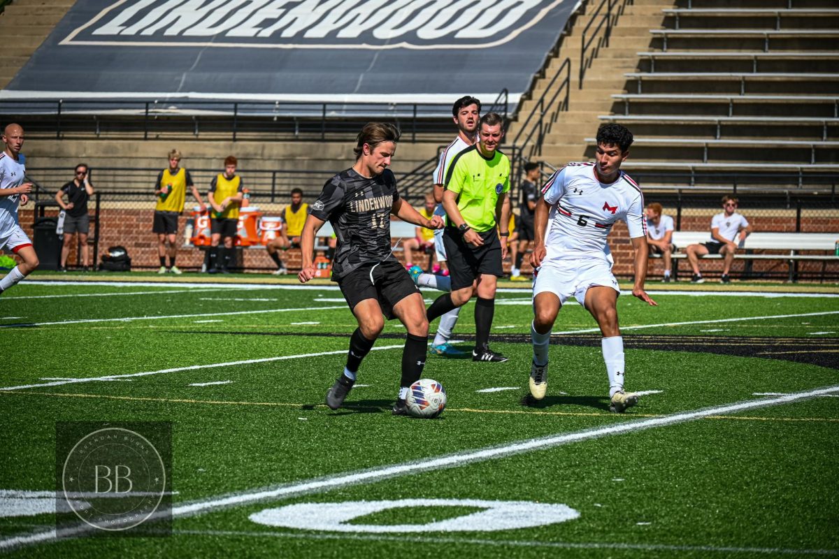 Midfielder Jonathan Campbell evades Maryville defenders as he moves the ball down the pitch.