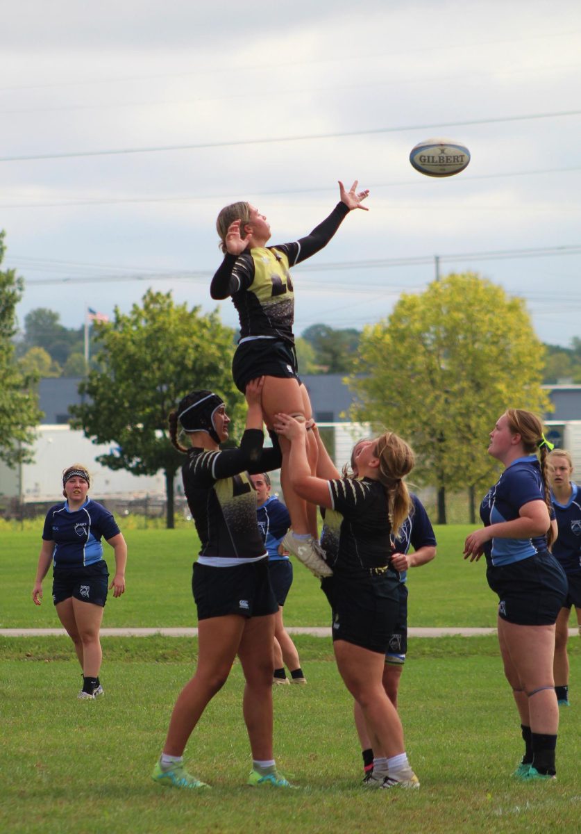 Members of the Lindenwood Lions women's rugby team participate in a lineout. 