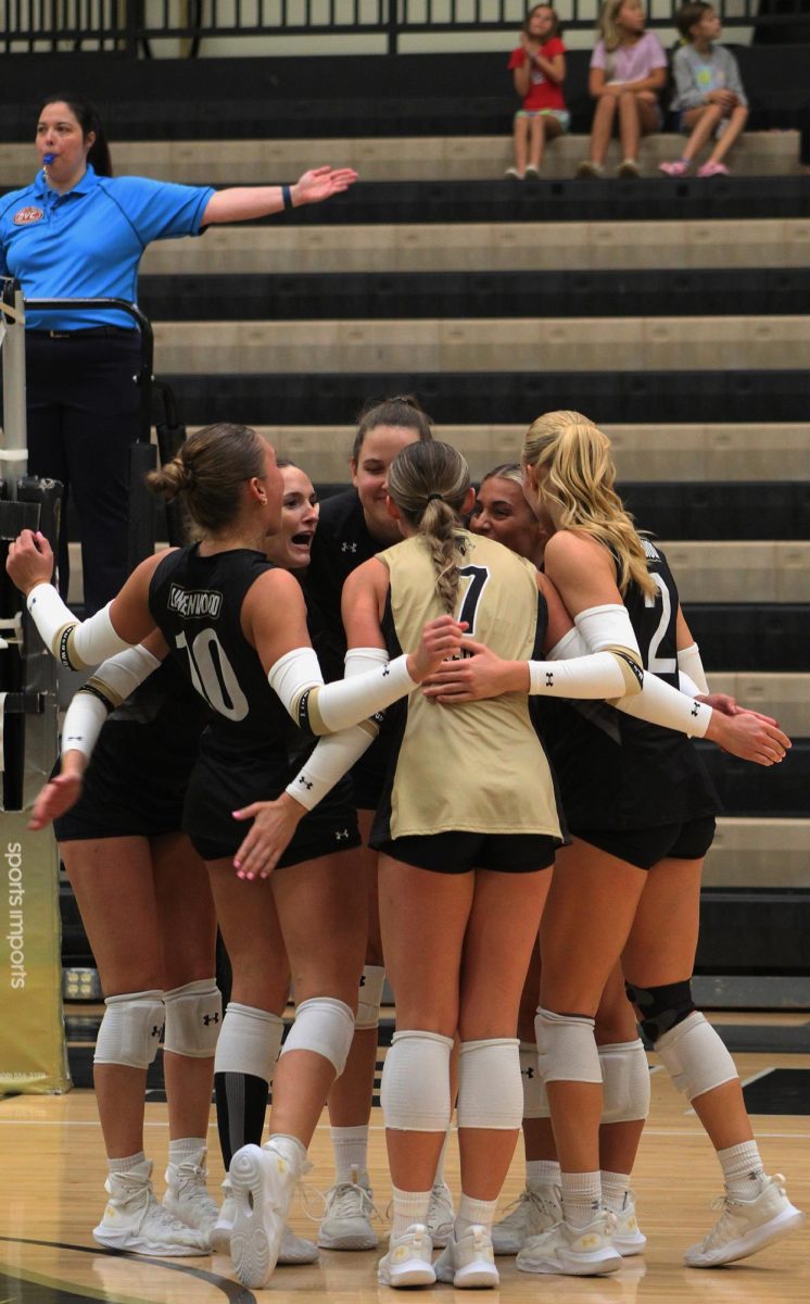 The Lindenwood Lions women's volleyball team celebrates after scoring a point against Eastern Illinois University. 