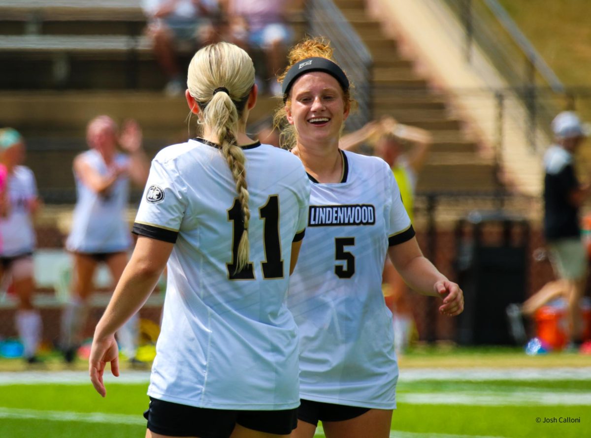 Jessica Dodd and Eyglo Thorsteinsdottir embrace each other after a Lindenwood Lions winner. 