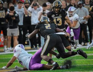 Ronnie Thomas Jr dives for a loose ball against Central Arkansas. 