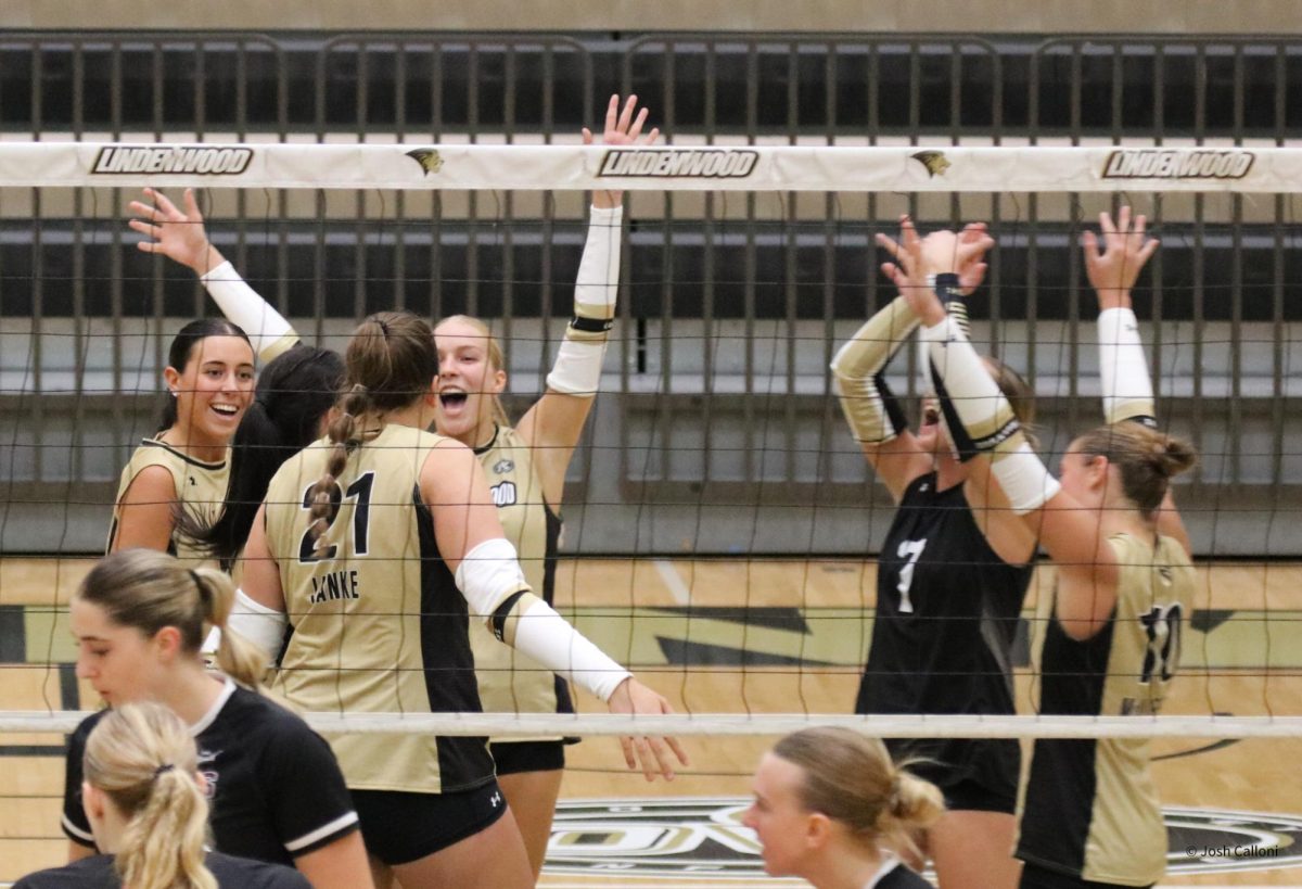 Members of the Lindenwood women's volleyball team celebrate a point against Southern Illinois. 