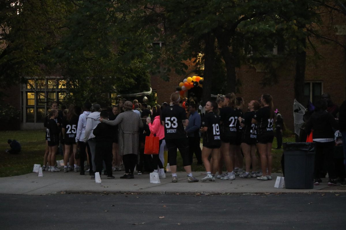 Carnival attendees wait outside of McCluer Hall at the entrance of the haunted house. 