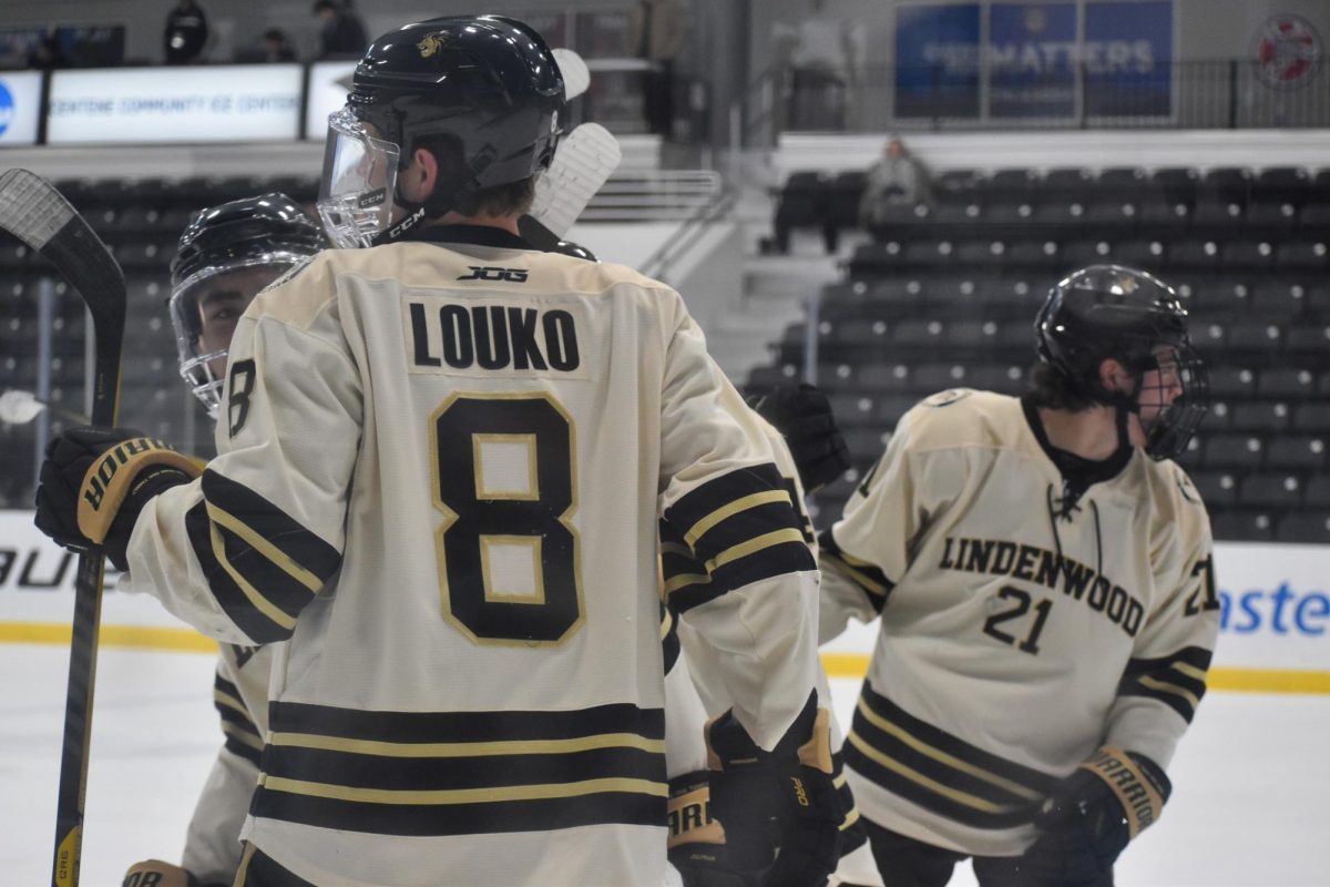 Jack Louko talks with Lindenwood teammates prior to a game against Weber State. 