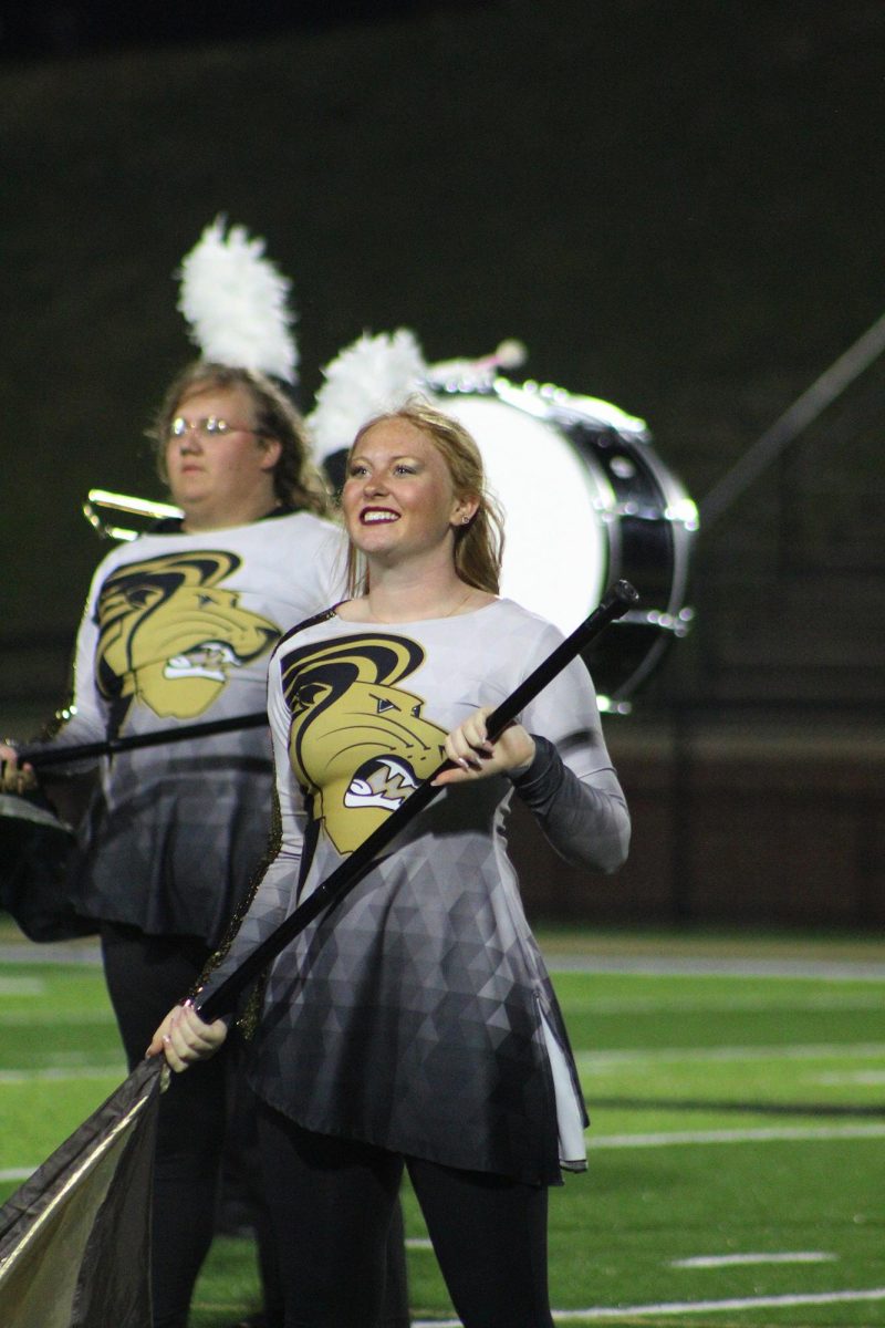 Lion's color guard member Emma performs at Hunter Stadium.  