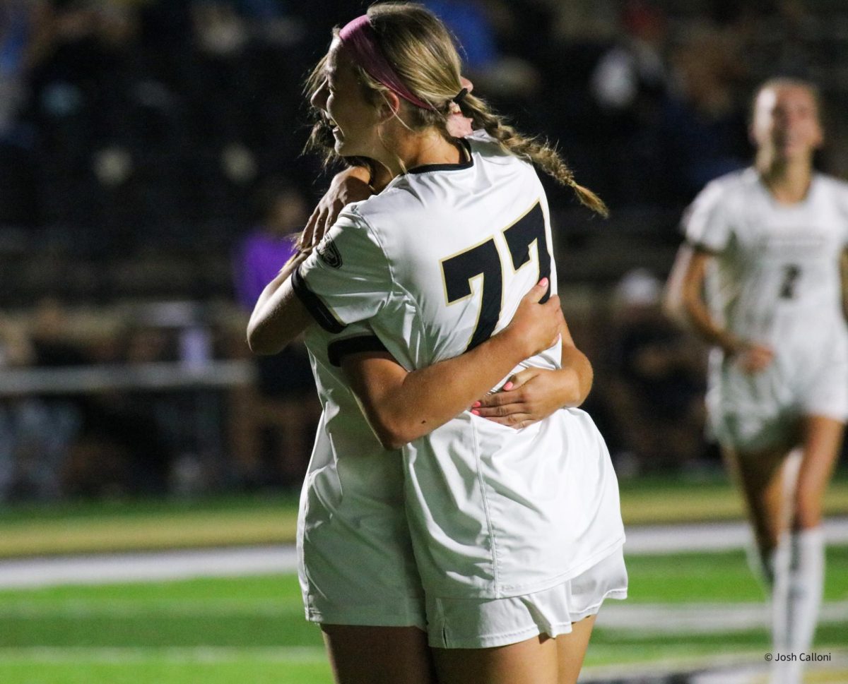 Mackenzie Compton embraces a teammate after scoring a goal against Southern Indiana. 