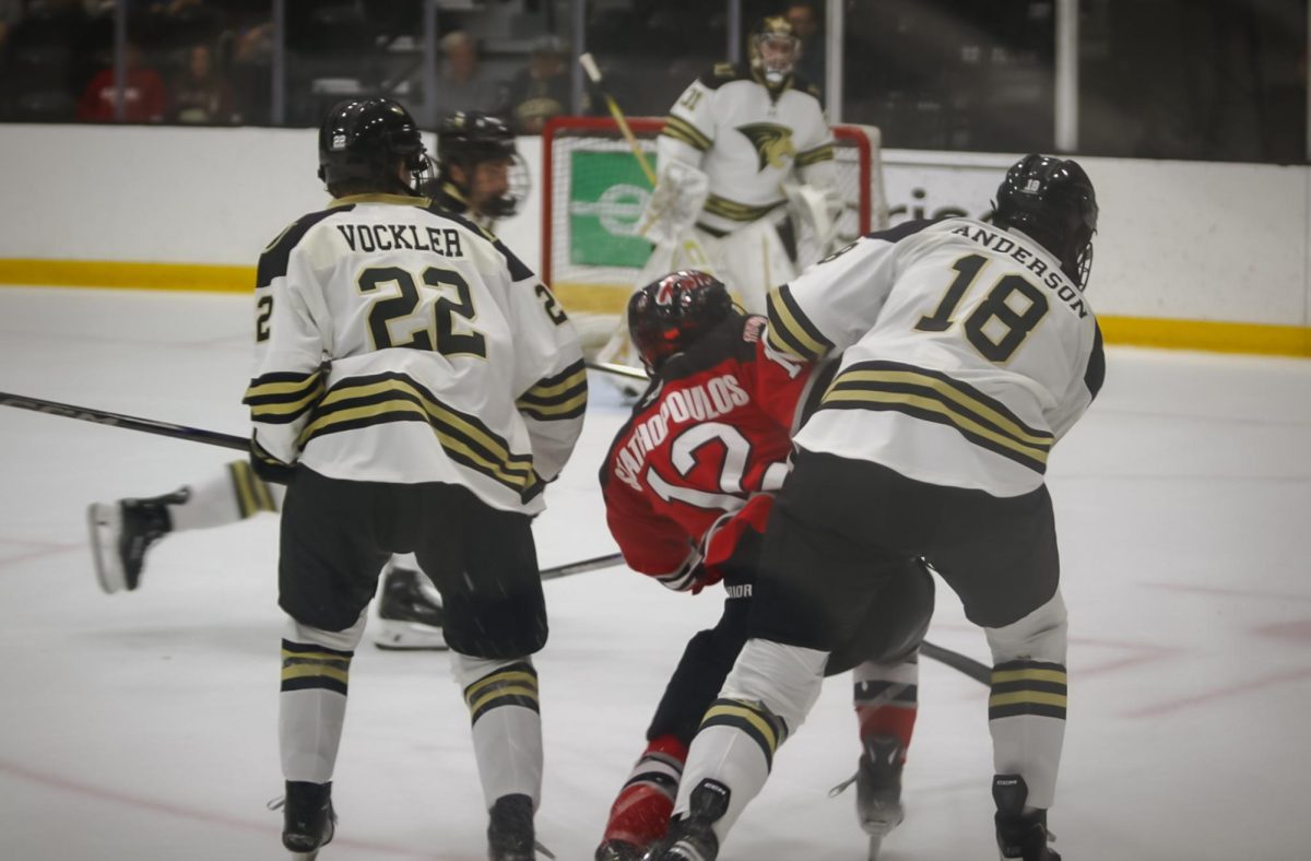 Jack Anderson and Jacob Vockler check a UNLV player. 