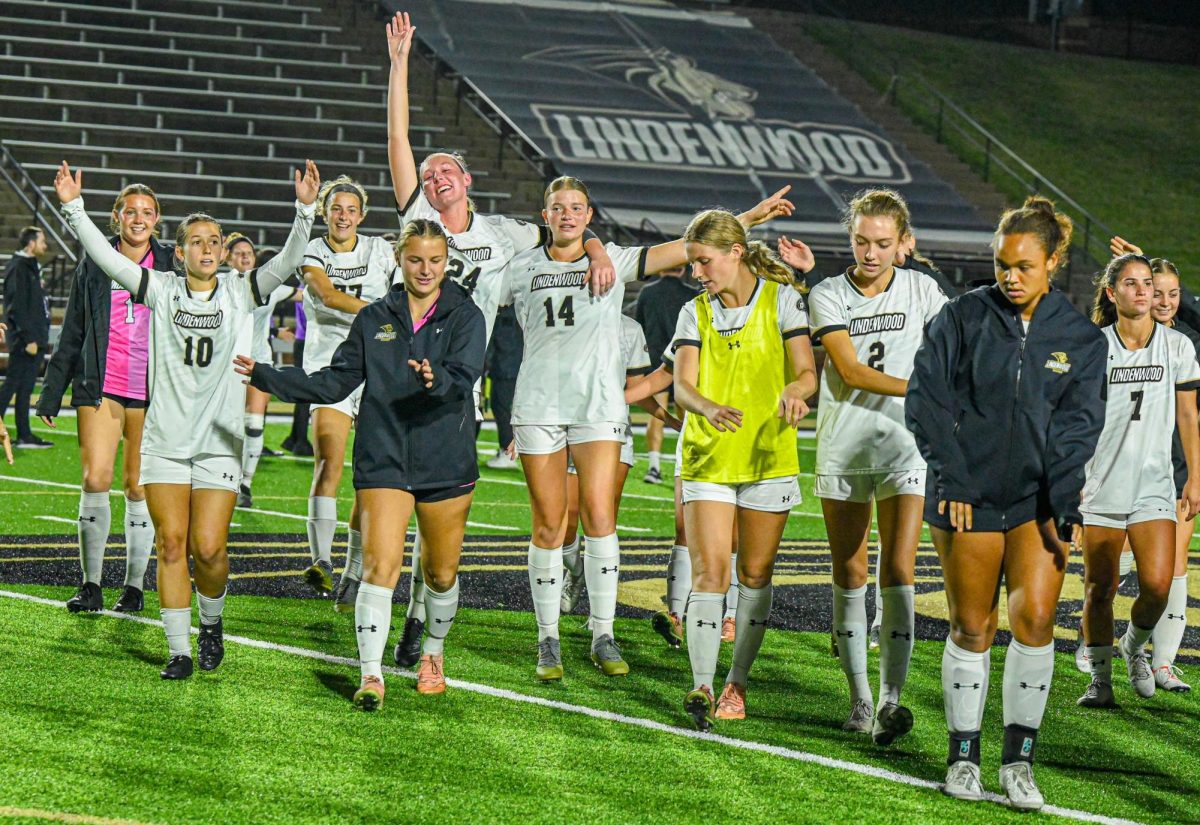 Members of the Lindenwood Lions women's soccer team celebrate after clinching a berth to the OVC Semifinal round. 