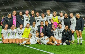 The Lindenwood Women's Soccer team poses for a photo after defeating SEMO to advance to the OVC Semifinals. 