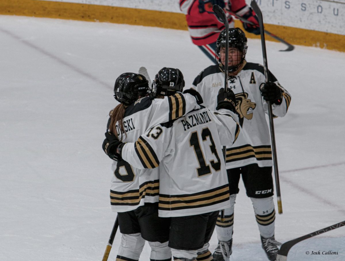 Zsofia Pazmandi and Olivia Grabianowski embrace each other after Pazmandi scores a goal against Syracuse. 