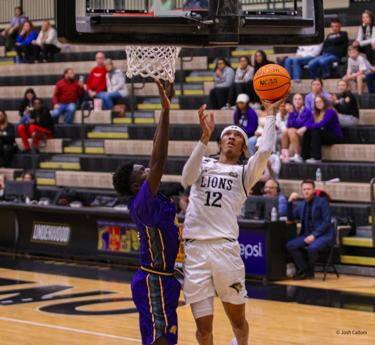 Anias Futrell goes for a contested layup against the University of Health and Science in St. Louis.