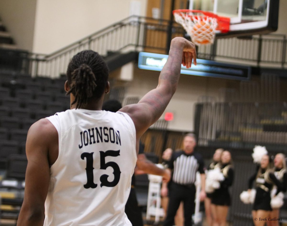 Nathan Johnson shoots a three-point shot against Harris-Stowe University. 