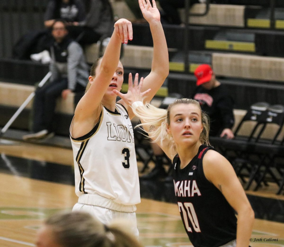 Gracy Wernli attempts a field goal shot over an Omaha player. 