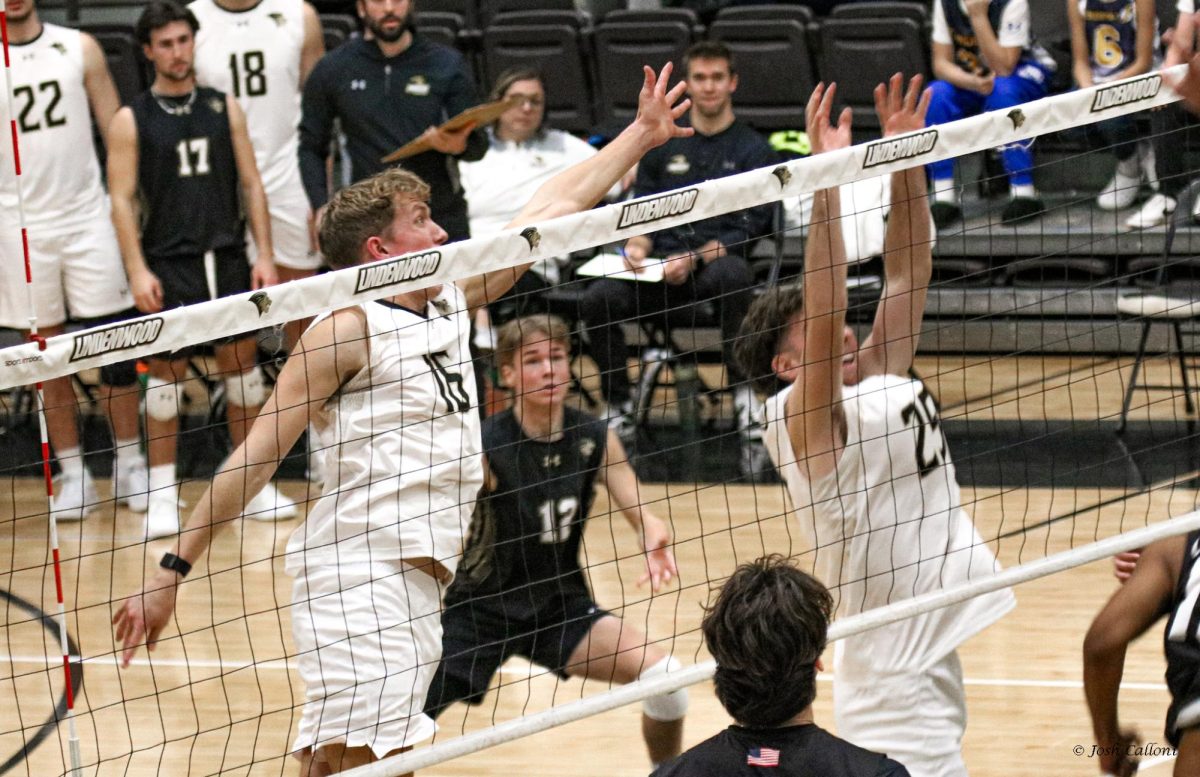 Zach Solomon and Owen Walsh go up to the net to attempt a block against Long Beach State. 