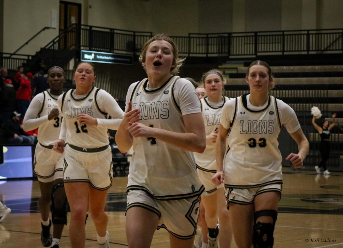 Ellie Brueggeman leads the Lions off the court after a win against SEMO. 