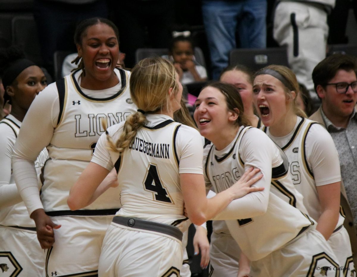 Ellie Brueggeman is embraced by Alyssa Nielsen, Mya Skoff and Mariah Stewart after he game-winning two-point conversion. 