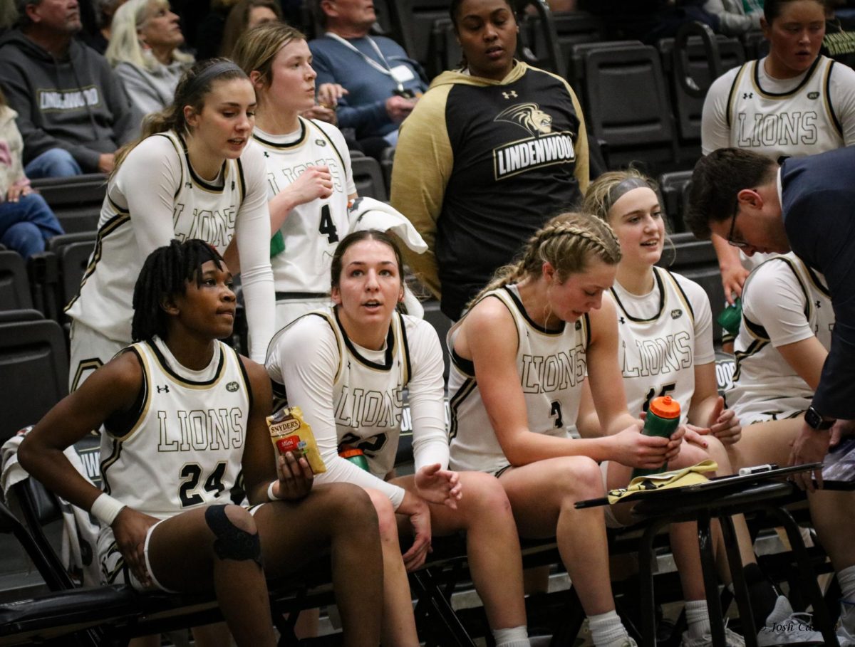 Mya Skoff, Gracy Wernly, Mykayla Cunningham and their Lions teammates huddle during a timeout against SIUE. 