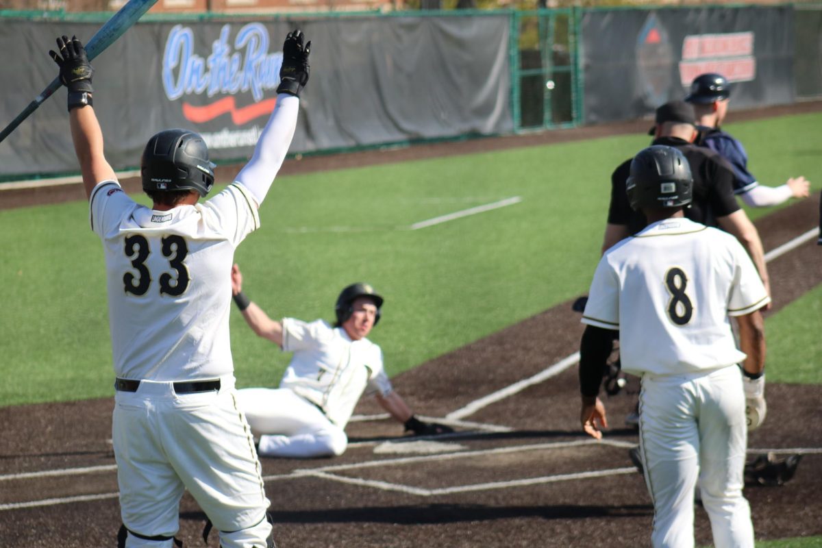 Jake Radosevich celebrates as Tyler Thompson slides into home against Butler. 