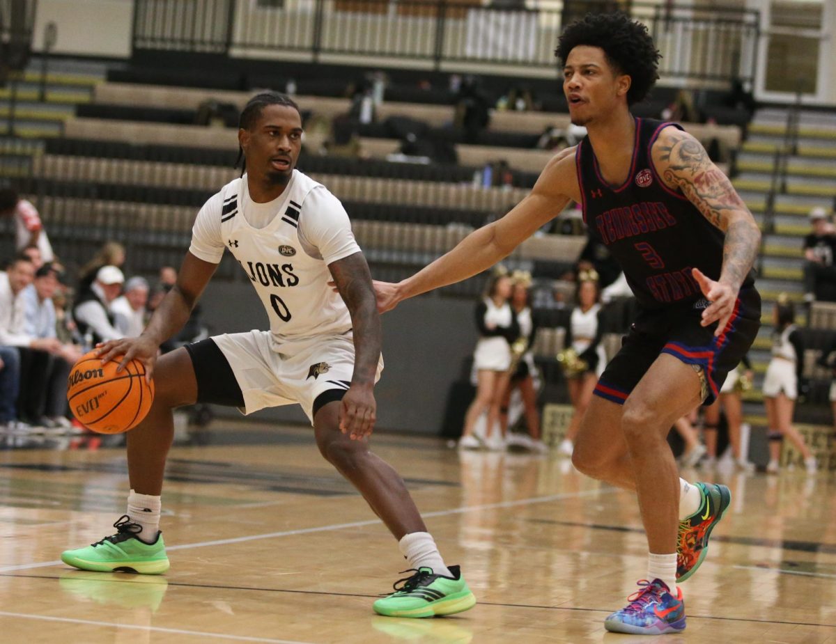 Mekhi Cooper dribbles the ball while being guarded by a Tennessee State player.