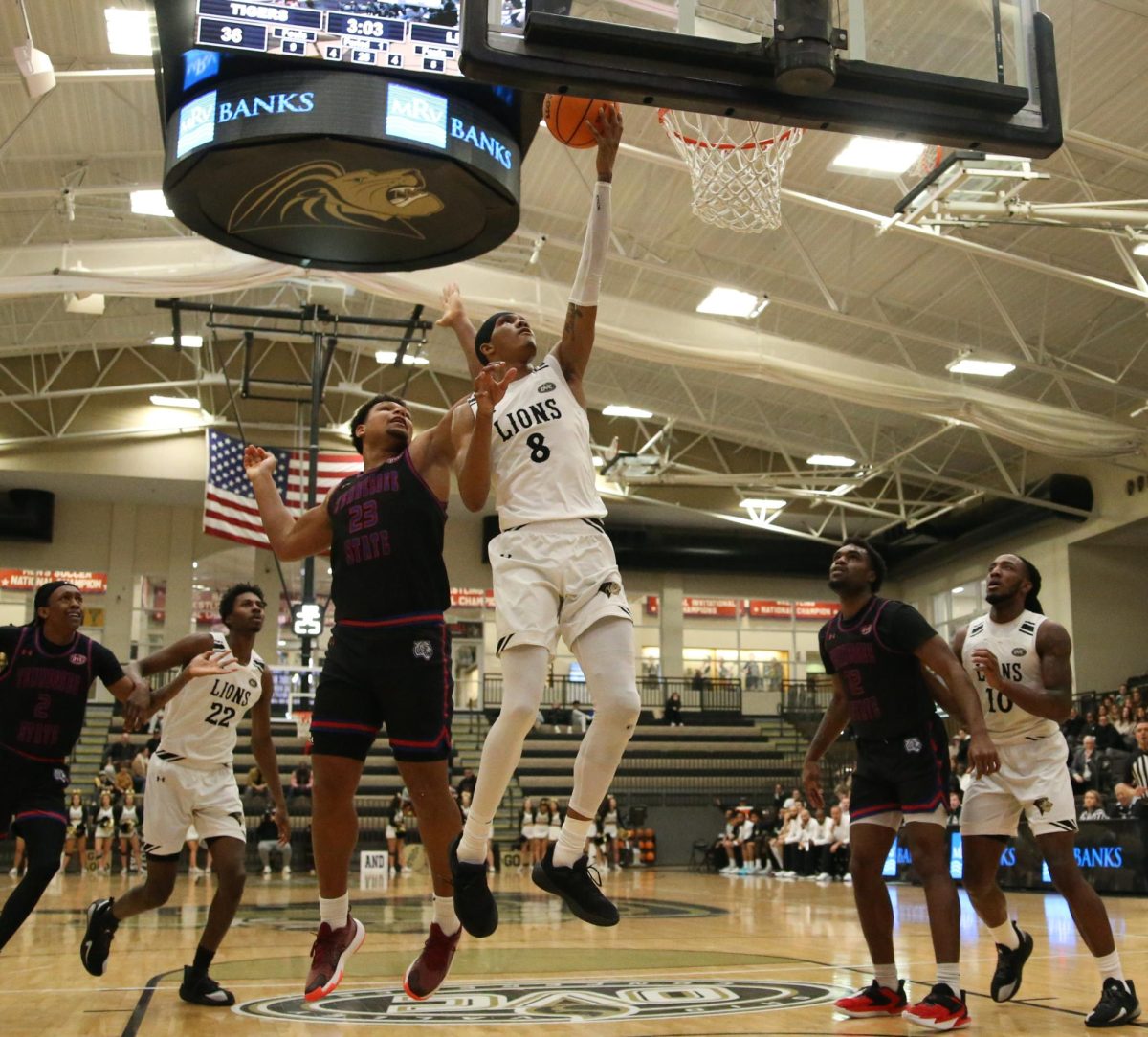 Anias Futrell maneuvers through traffic and gets to the rim with a left-handed layup.