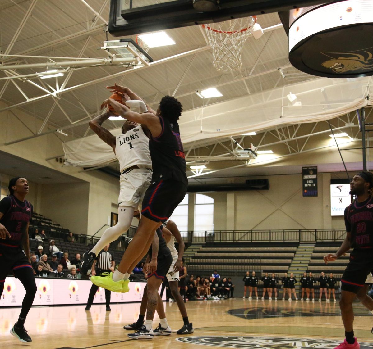 Dontrez Williams drives the rim and gets fouled by a Tennessee State player.