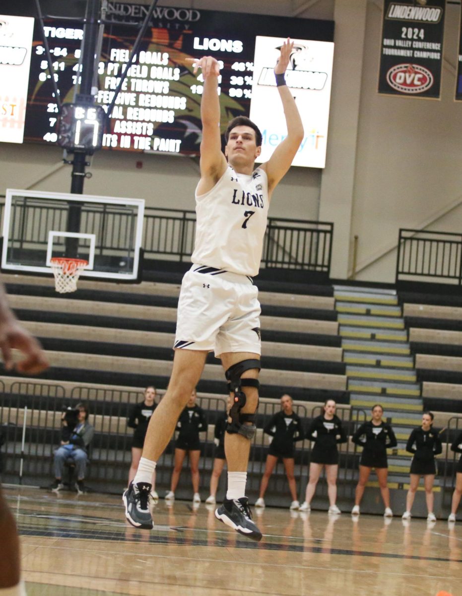 Milos Nenadic shoots a three pointer.
